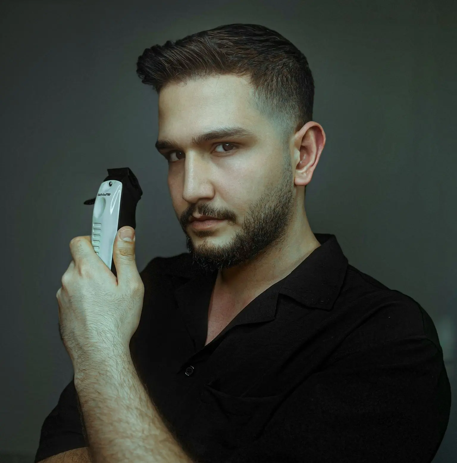 a man holding a remote control in his right hand